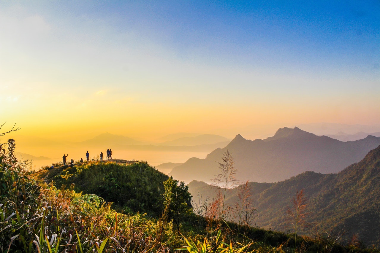 Home Photo Of People Standing On Top Of Mountain Near Grasses 733162 2